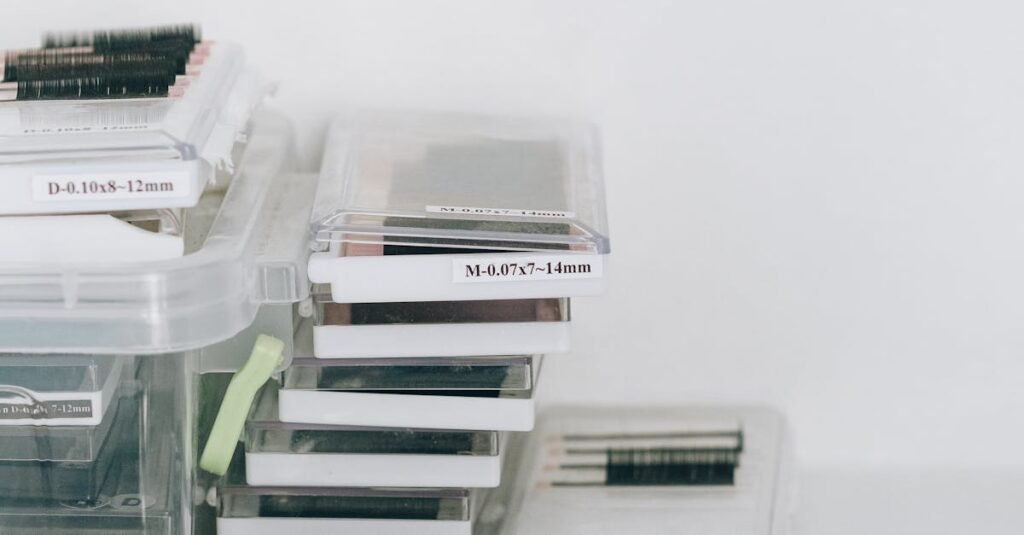 Clear plastic containers holding various eyelashes and extensions for beauty use.